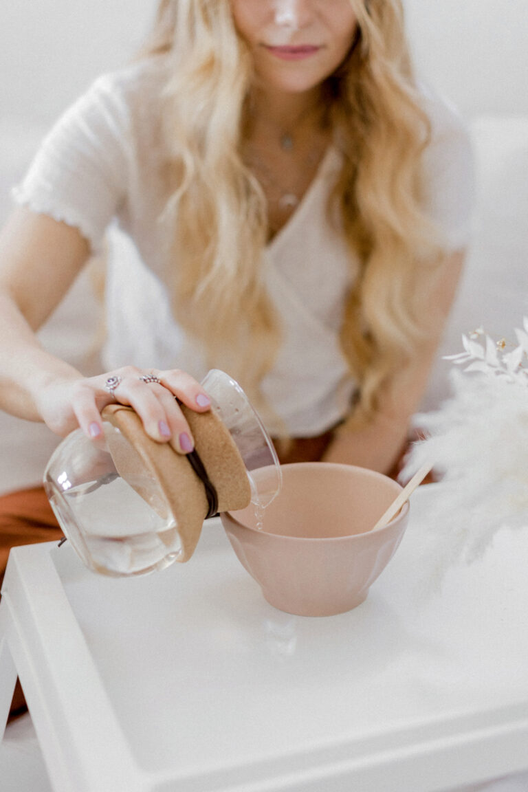 Woman making tea in a peaceful environment, trying to avoid intermittent fasting headache